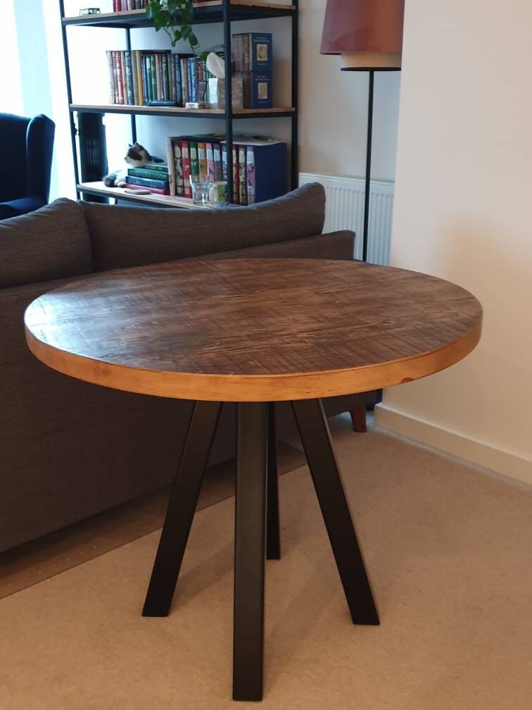 Round rustic dining table with central steel leg - The Grain Company Ltd