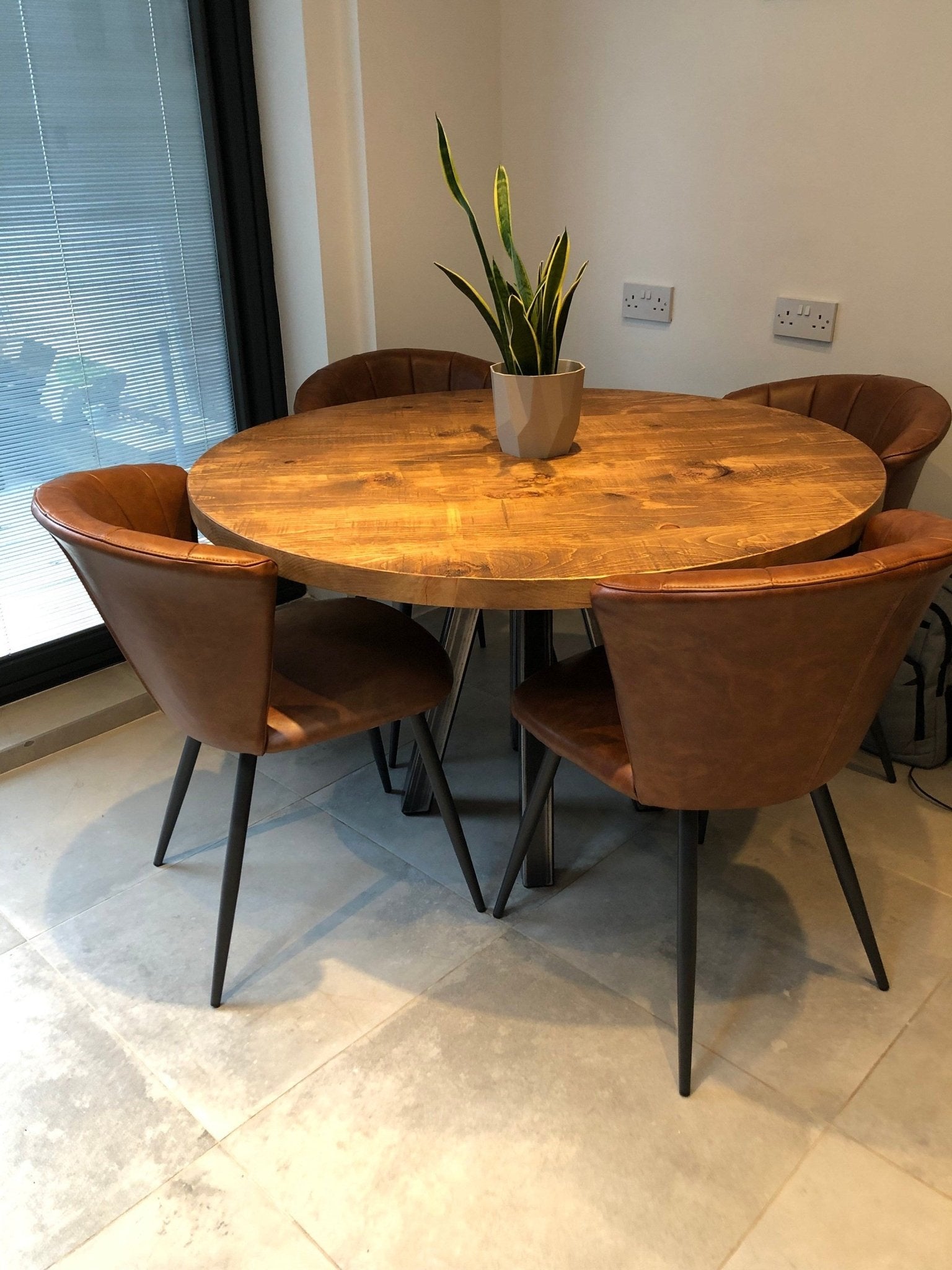 Round rustic dining table with central steel leg - The Grain Company Ltd