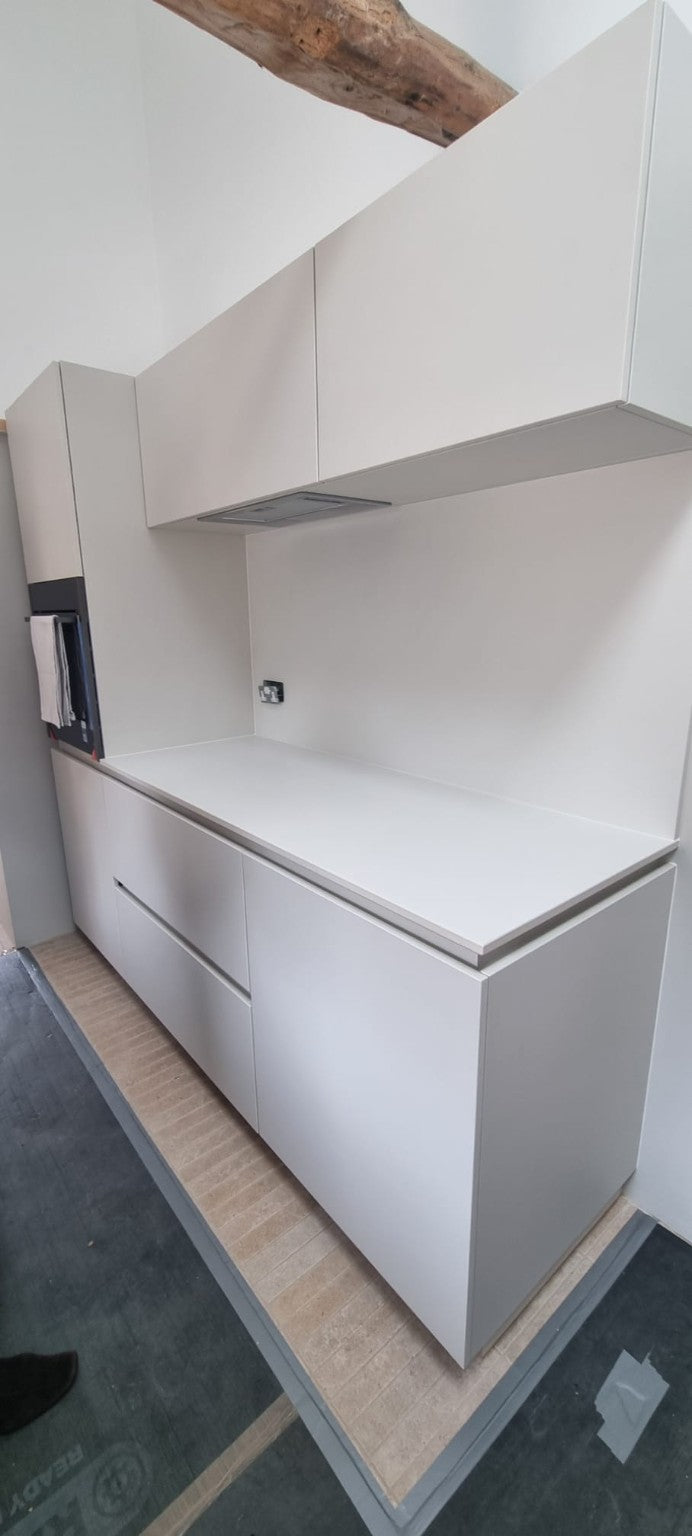 Handleless grey kitchen cabinetry with wall and base units