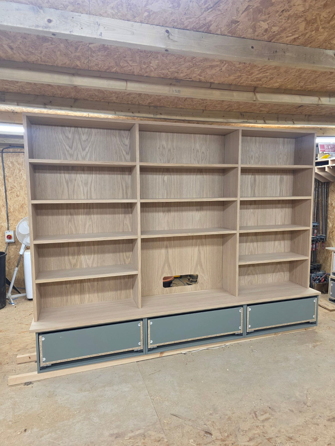 Large oak-effect media wall cabinet manufactured in the workshop